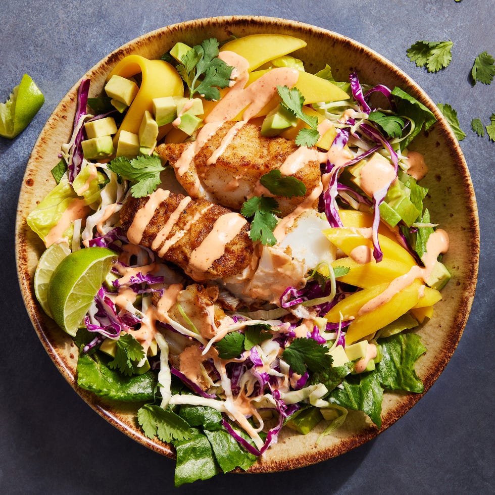 fish taco bowls with cabbage, mango, cilantro and a spicy cream drizzle