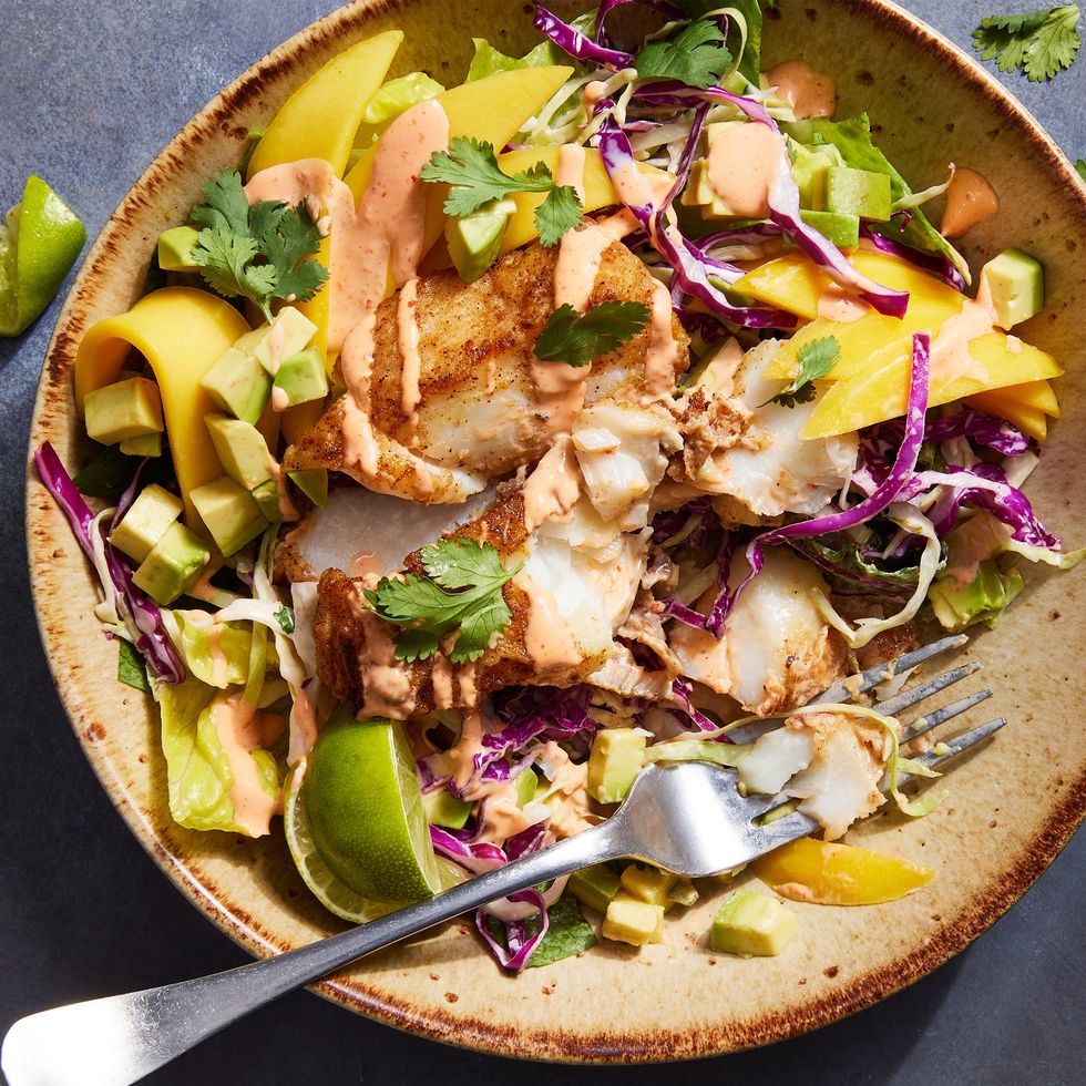 fish taco bowls with cabbage, mango, cilantro and a spicy cream drizzle