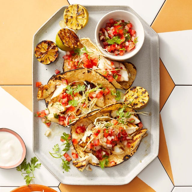 fish tacos with pico de gallo on a white plate