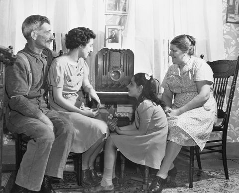 family gathered around radio