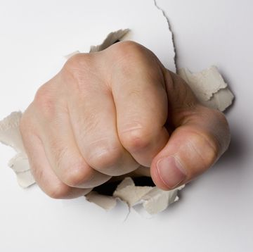 A fist breaking through a wall