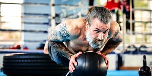 Fit male exercising with medicine ball in the gym