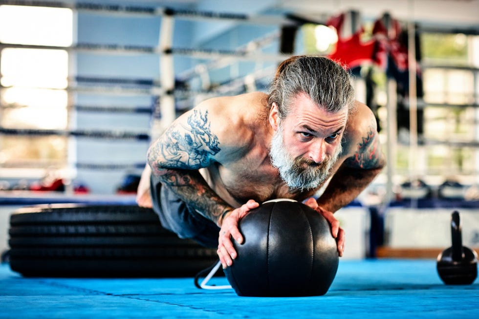 Fit male exercising with medicine ball in the gym