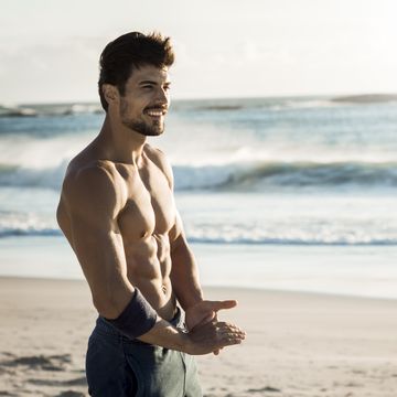fit man relaxing on the beach