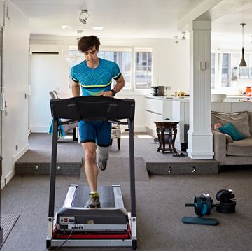 fit mid adult man working out at home on treadmill