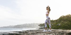 Fit Woman Doing Yoga Routine Looking at Ocean