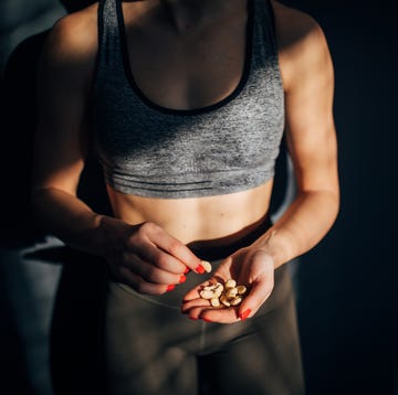 Fit woman eating healthy snack after training in the gym fit woman eating healthy snack after training in the gym