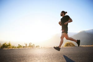 fit young man out for run on a sunny afternoon in summer