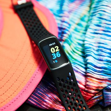 fitbit charge 5 with running hat and shorts