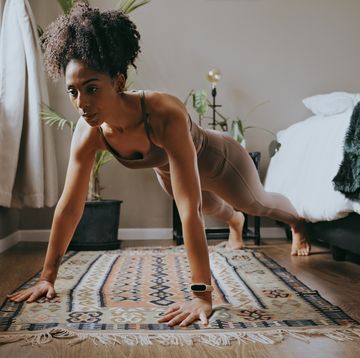 fitness, black woman and push up exercise in home for wellness, healthy lifestyle and workout young sports person, plank and female athlete on bedroom floor with strong core, body muscle and power