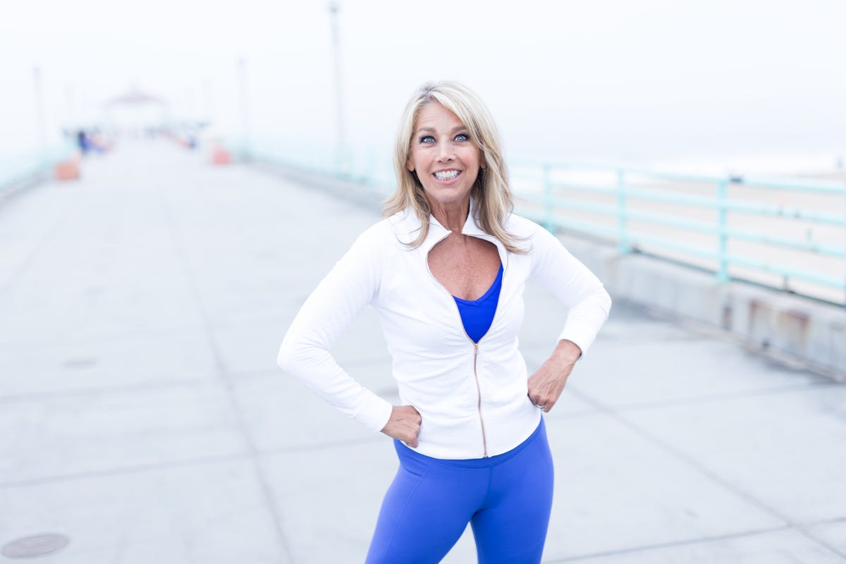 Premium Photo  Cropped image of a female figure in tight black leggings  take a side step, over white background. vertical view.