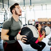 Fitness Enthusiasts Keeping Fit Using Weighted Balls