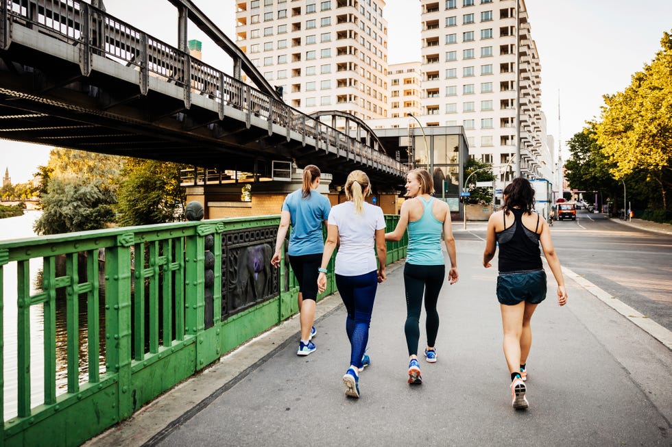 fitness group relaxing after jogging around the city