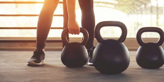 Fitness training with kettlebell in sport gym.