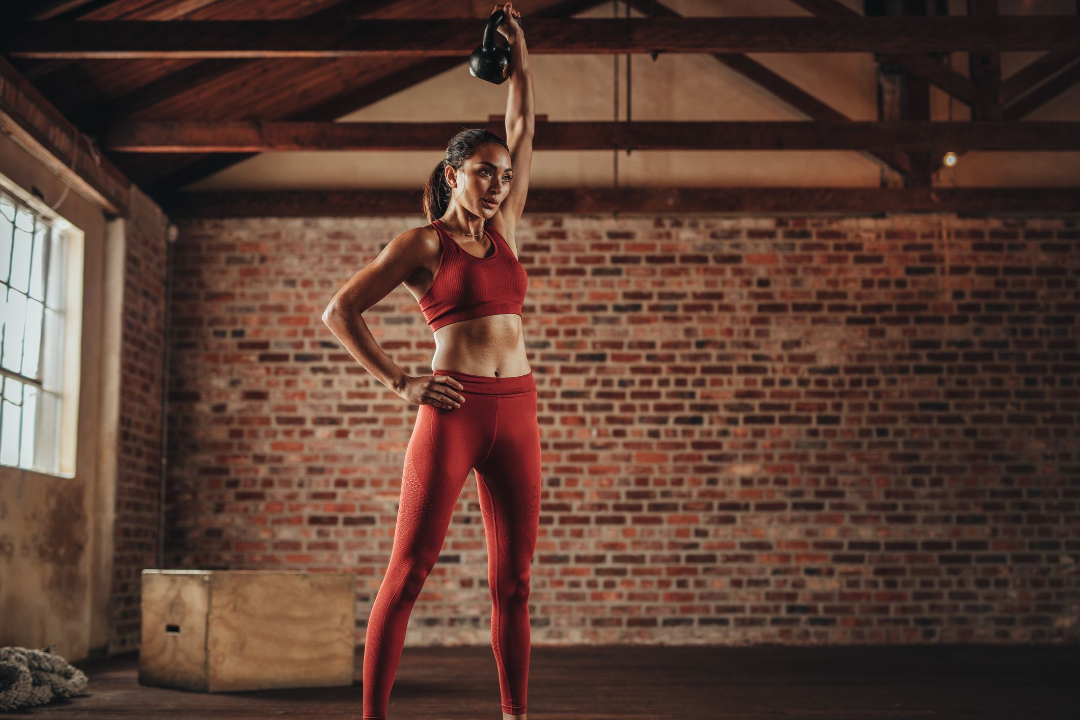 https://hips.hearstapps.com/hmg-prod/images/fitness-woman-doing-exercising-with-kettle-bell-royalty-free-image-1635538888.jpg