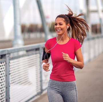 fitness woman jogging outdoors on bridge