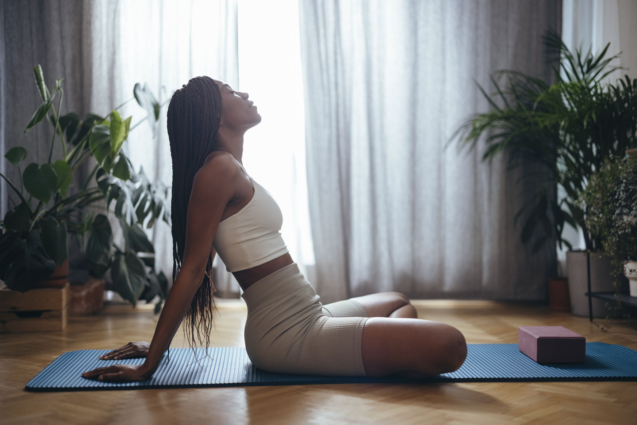 A Woman Doing a Yoga Exercise on a Yoga Mat · Free Stock Photo