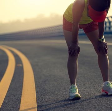 fitness woman runner running on seaside bridge