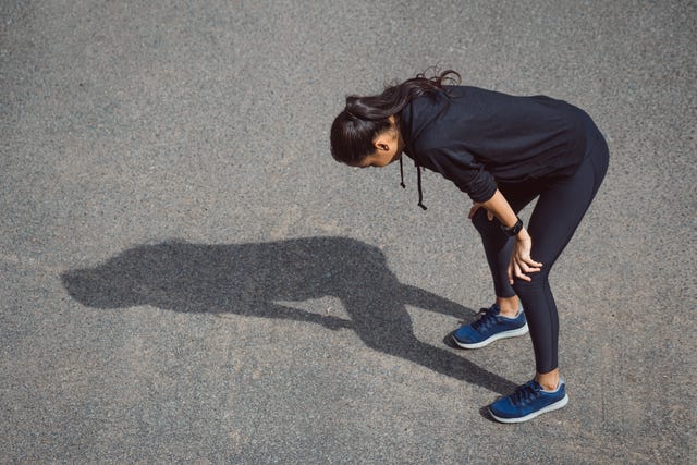 fitness woman she is running the road tired and hot from the sun