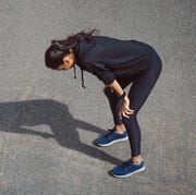 fitness woman she is running the road tired and hot from the sun