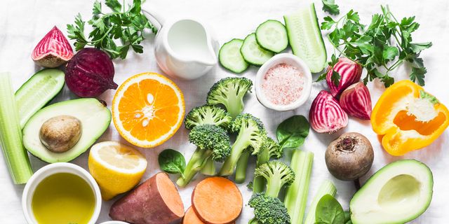 five best vitamins for beautiful skin products with vitamins a, b, c, e, k   broccoli, sweet potatoes, orange, avocado, spinach, peppers, olive oil, dairy, beets, cucumber, beens flat lay, top view