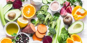 Five best vitamins for beautiful skin. Products with vitamins A, B, C, E, K - broccoli, sweet potatoes, orange, avocado, spinach, peppers, olive oil, dairy, beets, cucumber, beens. Flat lay, top view