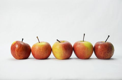 Five red apples on white background