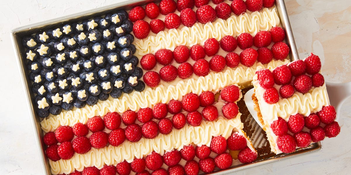 Flag Cake cake topped with raspberries, icing, and blueberries to create an american flag design
