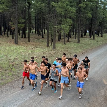 a group of runners on a gravel road a group of runners on a gravel road