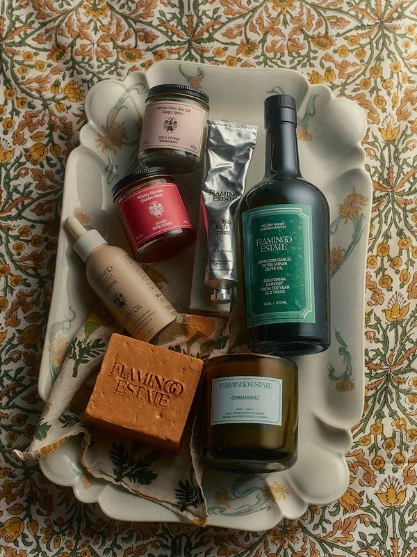 collection of skincare and gourmet products arranged on a decorative plate