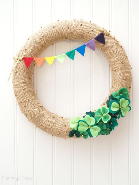 wreath made out of glittery gold burlap with green felt shamrocks at the bottom and a little felt rainbow at the top