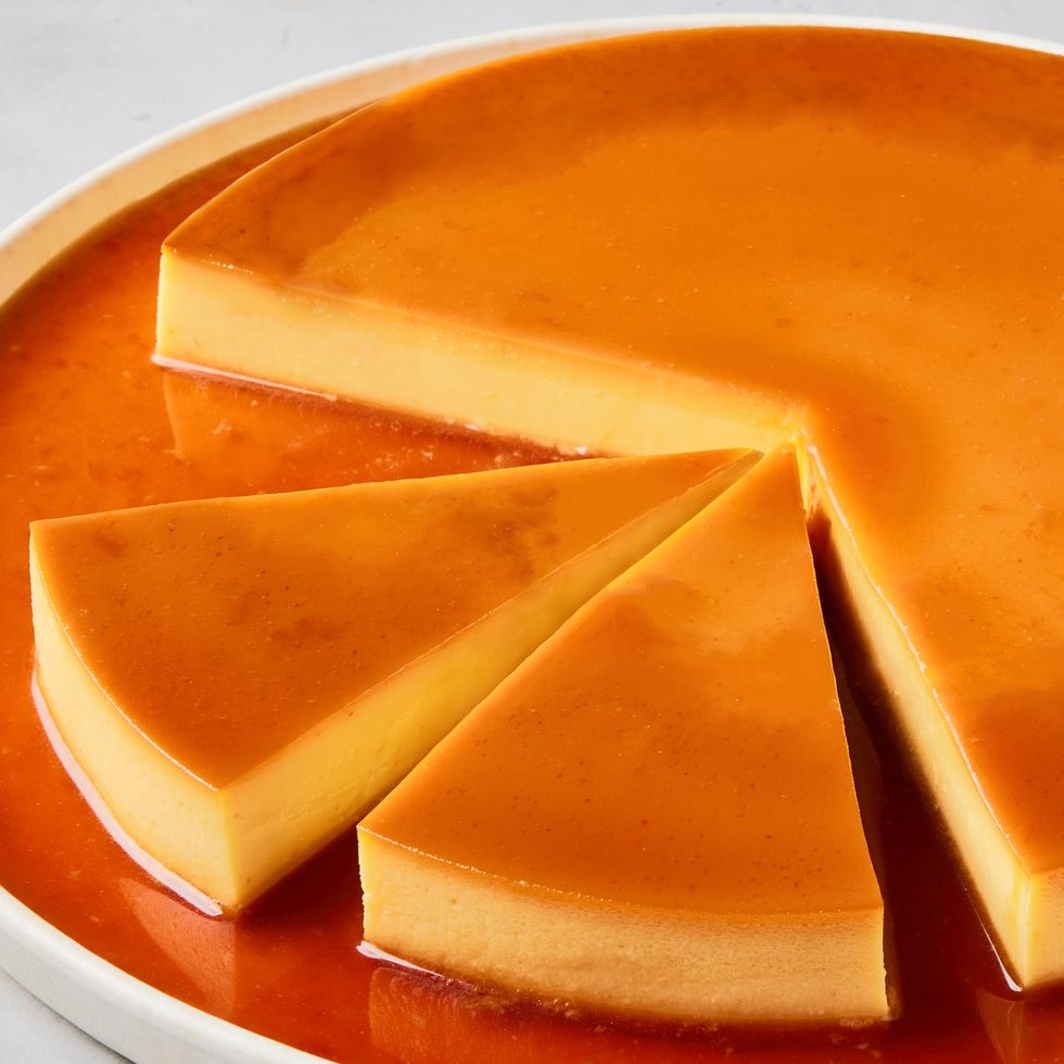 one large flan on a plate topped with caramel and sliced