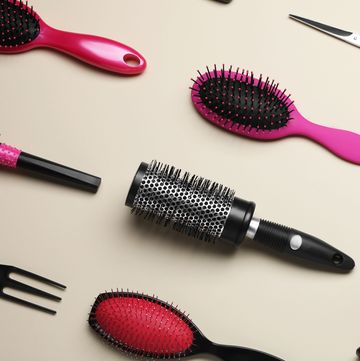 flat lay composition of professional hairdresser tools on beige table