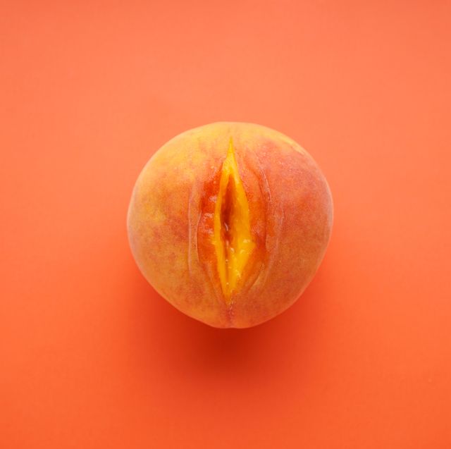 flat lay composition with juicy peach on a red background sex concept