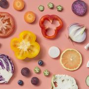 Flat lay conceptual vegan food on pastel colour background.