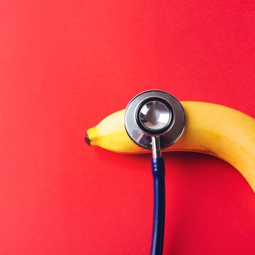 flat lay of doctor stethoscope and yellow banana