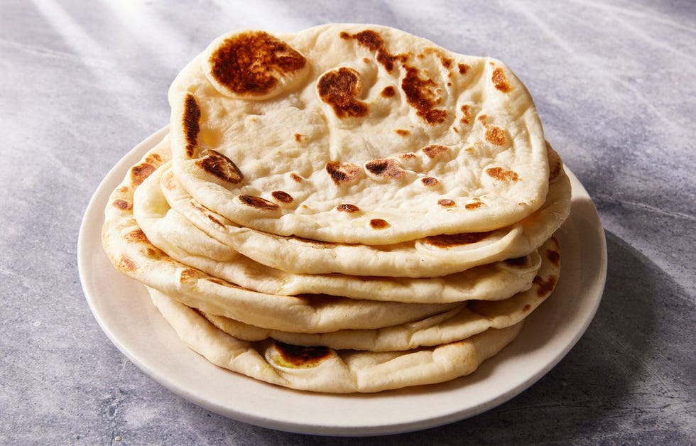 a stack of homemade naan on a plate