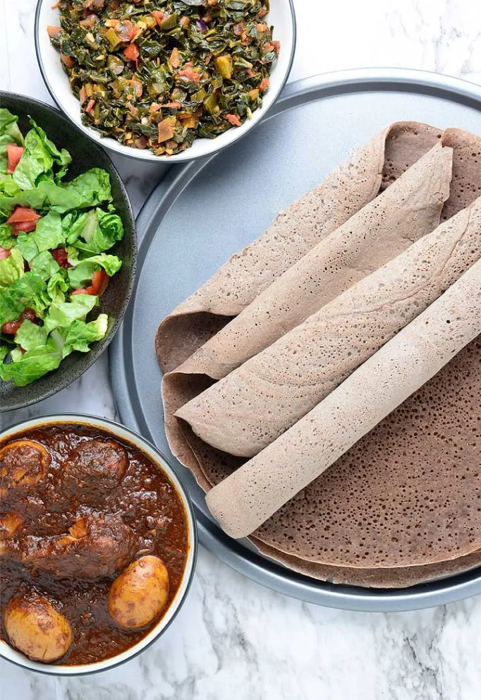 injera rolled up on a plate