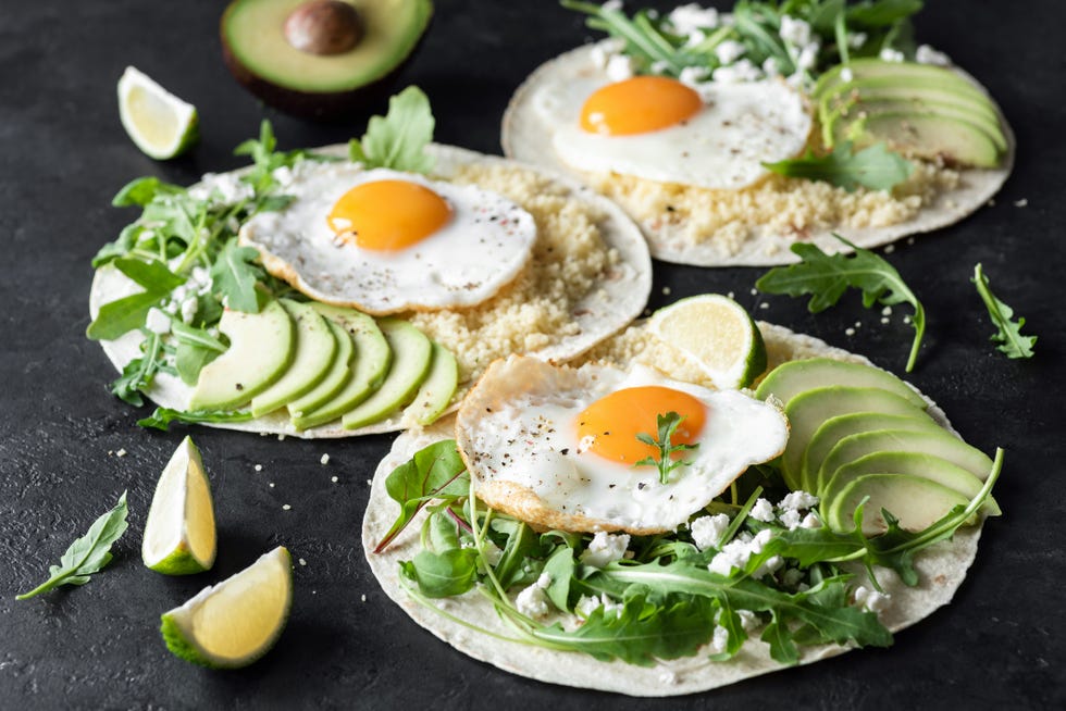 flatbread with avocado, egg, feta cheese and arugula salad