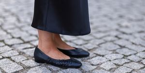 a person's legs in black shoes