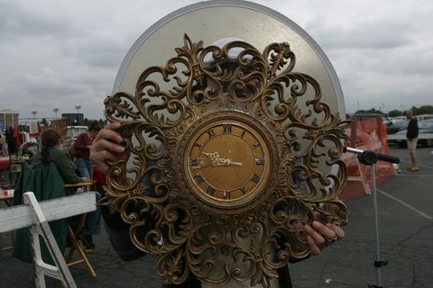 Flea market shopping, a shy Sugi Satoshi with an ornate clock purchased for $20. at the Long Beach