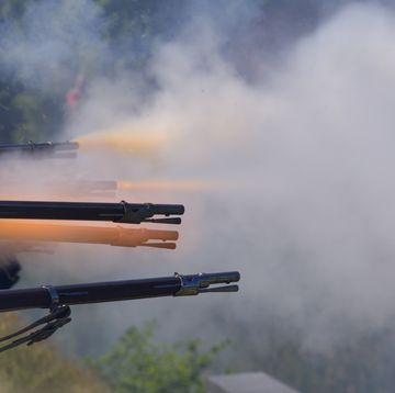 flintlock muzzle loader muskets guns firing smoke from the gunpowder fills the air