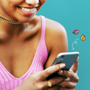 woman smiling at phone and texting
