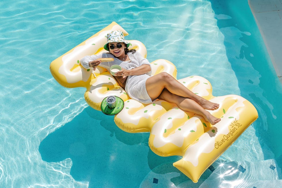a person relaxing on a foodthemed pool float in a swimming pool