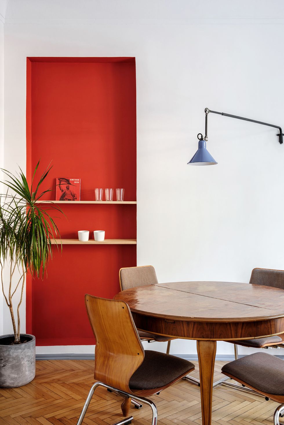 minimalist dining nook with red statement wall