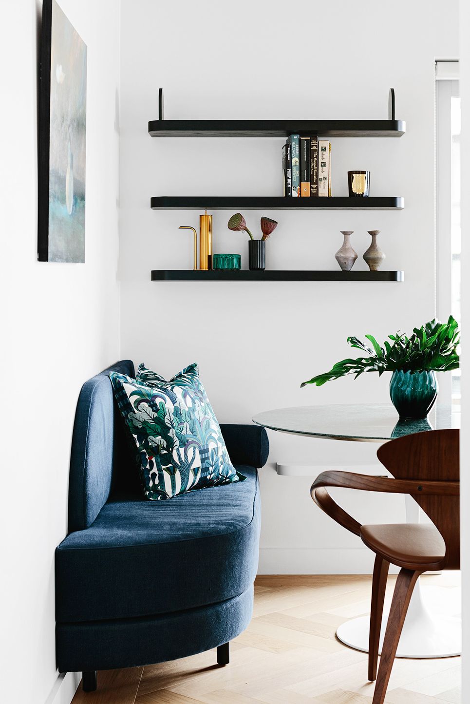 small modern breakfast nook with black floating shelves