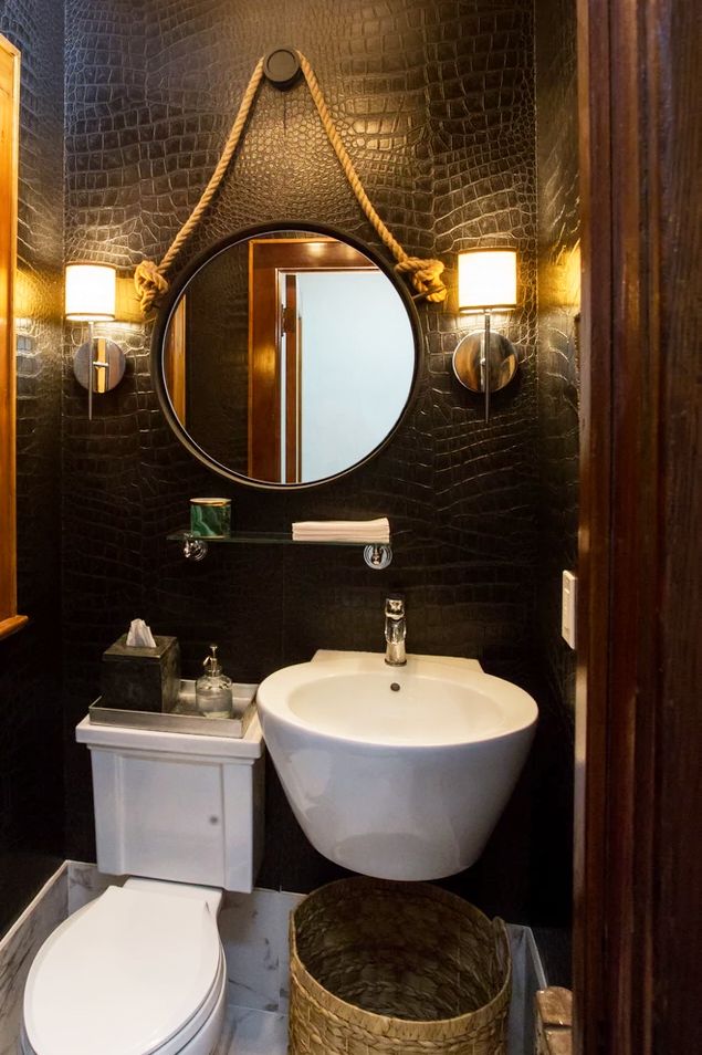 dark powder room with leather croc embossed wallpaper