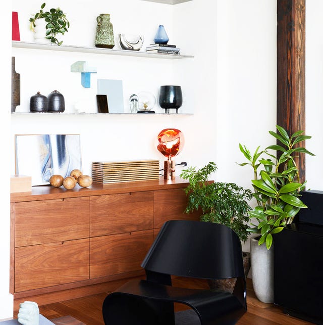 modern living room with colorful decor on floating shelves