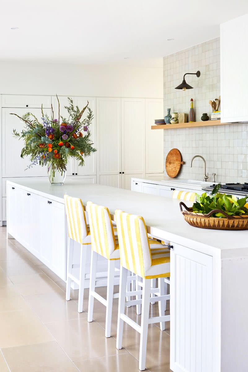 kitchen with yellow and white bar stools