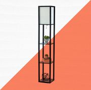 black floor lamp with shelves against orange and white background